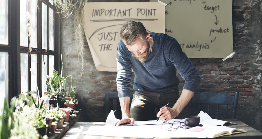 Business man making notes at desk